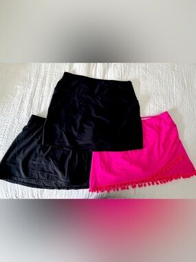 Set of 3 women’s XL swim skirts. 2 black one hot pink with Pom Pom detail